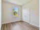 Cozy bedroom with a window, closet, light walls, and wood-look flooring, creating a welcoming space at 2729 36Th N Ave, St Petersburg, FL 33713