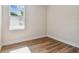An empty bedroom with hardwood floors, white walls and trim, and a bright window at 2729 36Th N Ave, St Petersburg, FL 33713