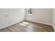 Bright bedroom with wood-look flooring, base molding, and a large window, perfect for relaxation at 2729 36Th N Ave, St Petersburg, FL 33713