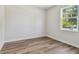Bright bedroom featuring wood-look floors and a window that offers natural light and views of the outdoors at 2729 36Th N Ave, St Petersburg, FL 33713