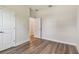 Bedroom with a door leading to another room, paired with modern wood-look floors and neutral wall paint at 2729 36Th N Ave, St Petersburg, FL 33713