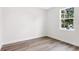 Empty bedroom with light colored walls, hardwood floors, and a view of tropical greenery at 2729 36Th N Ave, St Petersburg, FL 33713