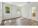 Bedroom features wood-look floors, white walls, and large windows at 2729 36Th N Ave, St Petersburg, FL 33713