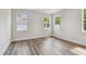 Bright bedroom features wood-look floors, crisp white walls, and large windows at 2729 36Th N Ave, St Petersburg, FL 33713