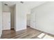 Bright bedroom with wood-look floors, showing door and closet, and neutral walls, creating a relaxing space at 2729 36Th N Ave, St Petersburg, FL 33713