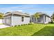 A single-Gathering home showcases a well-manicured lawn, stylish exterior, and a detached garage at 2729 36Th N Ave, St Petersburg, FL 33713