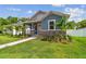 Attractive single-Gathering home featuring fresh landscaping, a walkway, and stone accents, creating a warm curb appeal at 2729 36Th N Ave, St Petersburg, FL 33713