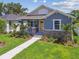 Charming home with stone accents, a bright yellow front door, and a lush, well-maintained lawn at 2729 36Th N Ave, St Petersburg, FL 33713