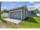 Detached garage and extra parking and curb appeal with neatly maintained lawn and blue exterior at 2729 36Th N Ave, St Petersburg, FL 33713