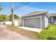 Garage exterior shows a stylish carriage door, tidy yard, and craftsman-style home architecture at 2729 36Th N Ave, St Petersburg, FL 33713