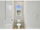 Bright half-bath featuring a toilet and window at 2729 36Th N Ave, St Petersburg, FL 33713