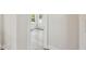 Hallway showcases the new gray wood-look floors and white trim leading to bedroom at 2729 36Th N Ave, St Petersburg, FL 33713