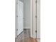 Hallway featuring wood-look floors, base molding, and white doors with modern hardware at 2729 36Th N Ave, St Petersburg, FL 33713