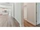 Elegant hallway with wood flooring, leading to the kitchen and featuring stylish white trim at 2729 36Th N Ave, St Petersburg, FL 33713