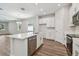 Open kitchen and living room with stainless steel appliances, island sink, and hardwood floors at 2729 36Th N Ave, St Petersburg, FL 33713