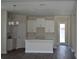 Bright kitchen with white cabinets, an island, hardwood floors, and stainless steel appliances at 2729 36Th N Ave, St Petersburg, FL 33713