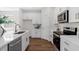 Bright kitchen featuring white cabinets, stainless steel appliances, and a modern countertop at 2729 36Th N Ave, St Petersburg, FL 33713