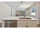 Kitchen island featuring stainless steel dishwasher and sink, overlooks living room and entry at 2729 36Th N Ave, St Petersburg, FL 33713