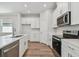 Well-appointed kitchen with stainless steel appliances, bright white cabinets, and quartz countertops at 2729 36Th N Ave, St Petersburg, FL 33713