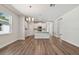 Hardwood floors flow into a white kitchen with a center island from the living room at 2729 36Th N Ave, St Petersburg, FL 33713