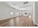 An open-concept living room with hardwood floors and an adjoining kitchen area at 2729 36Th N Ave, St Petersburg, FL 33713