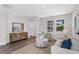 Inviting living room featuring a wood accent cabinet, neutral palette, and large windows at 2729 36Th N Ave, St Petersburg, FL 33713