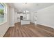 An open-concept living room featuring hardwood floors leading into the kitchen area at 2729 36Th N Ave, St Petersburg, FL 33713