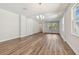 Bright, open-concept living room with wood-look flooring and ample natural light from large windows at 2729 36Th N Ave, St Petersburg, FL 33713