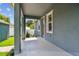 Spacious front porch with concrete flooring and charming architectural details, perfect for relaxing outdoors at 2729 36Th N Ave, St Petersburg, FL 33713