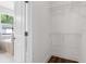 Bright walk-in closet featuring built-in white wire shelving, light walls, and a dark wood floor at 2729 36Th N Ave, St Petersburg, FL 33713