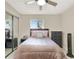 Bright bedroom featuring a queen bed, dresser, and mirrored closet at 3869 S Lake Dr # 146, Tampa, FL 33614