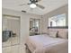 Spacious bedroom with a queen bed, dresser, and mirrored closet at 3869 S Lake Dr # 146, Tampa, FL 33614