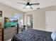 Bright bedroom with a large TV, dresser, and comfortable bed at 3869 S Lake Dr # 146, Tampa, FL 33614