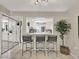 Kitchen with white cabinets, breakfast bar and view to the outdoors at 3869 S Lake Dr # 146, Tampa, FL 33614