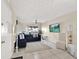 Living room with sectional sofa, two armchairs, and a large TV at 3869 S Lake Dr # 146, Tampa, FL 33614