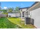 Backyard with a large patio and grassy area, AC unit visible at 4901 W Bartlett Dr, Tampa, FL 33603