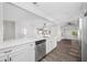 Modern white kitchen with stainless steel appliances and quartz countertops at 4901 W Bartlett Dr, Tampa, FL 33603