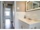 Bathroom with white vanity, tiled walls, and a framed mirror at 74 Palm Blvd, Dunedin, FL 34698