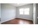 Simple bedroom with hardwood floors and a window at 74 Palm Blvd, Dunedin, FL 34698