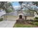 Three-car garage, attractive landscaping, and curb appeal at 8719 Ashworth Dr, Tampa, FL 33647