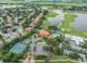 Aerial view of community with golf course, tennis courts, and clubhouse at 10628 Pontofino Cir, Trinity, FL 34655