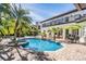 Inviting pool area with patio and lush landscaping at 10628 Pontofino Cir, Trinity, FL 34655