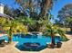 Large swimming pool with a spa and surrounding palm trees at 10628 Pontofino Cir, Trinity, FL 34655