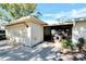 House exterior with attached garage and porch at 1510 Ingram Dr, Sun City Center, FL 33573