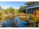 Relaxing pond with tropical plants and a unique sculpture at 1751 Hunter Creek Dr, Punta Gorda, FL 33982