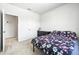 Bright bedroom with carpeted floor, floral bedding, and ample closet space at 1820 47Th N Ave, St Petersburg, FL 33714