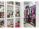 Large closet with glass-front shelving and hanging racks at 1820 47Th N Ave, St Petersburg, FL 33714