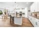 Open concept kitchen with island, white cabinets, and hardwood floors at 1820 47Th N Ave, St Petersburg, FL 33714