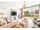 Living room with beige couch, chandelier, and sliding glass doors at 1820 47Th N Ave, St Petersburg, FL 33714