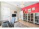 Home office with a red accent wall and built-in shelving at 1820 47Th N Ave, St Petersburg, FL 33714